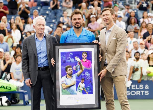 US Open Tournament Director Eric Butorac and USTA CEO Craig Tiley present Stan Wawrinka of Switzerland with a gift after his first round match against Matteo Berrettini in The Grandstand at the 2026 US Open Tennis Championship at the USTA Billie Jean King National Tennis Center in New York City on Monday, August 31, 2026. Stan Wawrinka ended his Grand Slam career with his loss to Berrettini in straight sets.  NYP20260831113 JOHNxANGELILLO