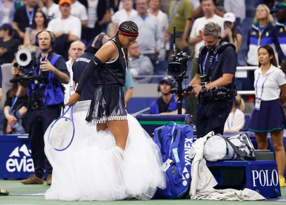 Naomi Osaka of Japan removes part of her arrival fashion after she is introduced before her first round match against Anastasia Zakharova in Arthur Ashe Stadium at the 2026 US Open Tennis Championship at the USTA Billie Jean King National Tennis Center in New York City on Monday, August 31, 2026.  NYP20260831148 JOHNxANGELILLO