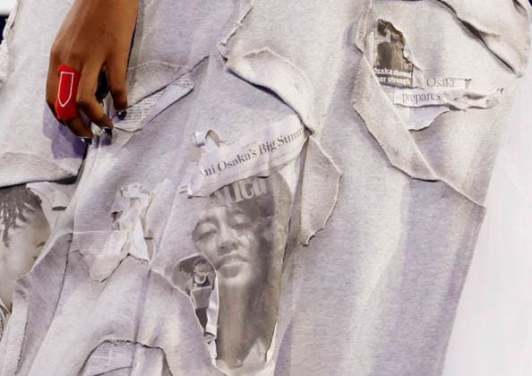 Naomi Osaka of Japan wears a dress design with newspaper clippings regarding herself when she was introduced before her first round match against Anastasia Zakharova in Arthur Ashe Stadium at the 2026 US Open Tennis Championship at the USTA Billie Jean King National Tennis Center in New York City on Monday, August 31, 2026.  NYP20260831149 JOHNxANGELILLO