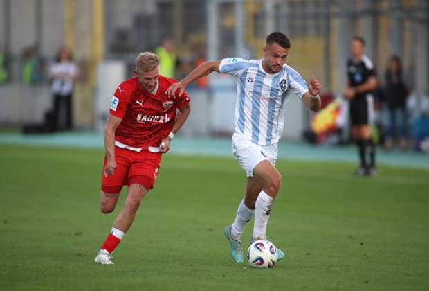 Soccer, Men s, Toto Cup, Quarterfinals, 2026–2027 Season, TSV 1860 Munich vs. TSV Buchbach at Grünwalder Stadium: Tobias Sztaf of TSV Buchbach (left) and Raphael Wach of TSV 1860 Munich (right) battle for the ball during an attack