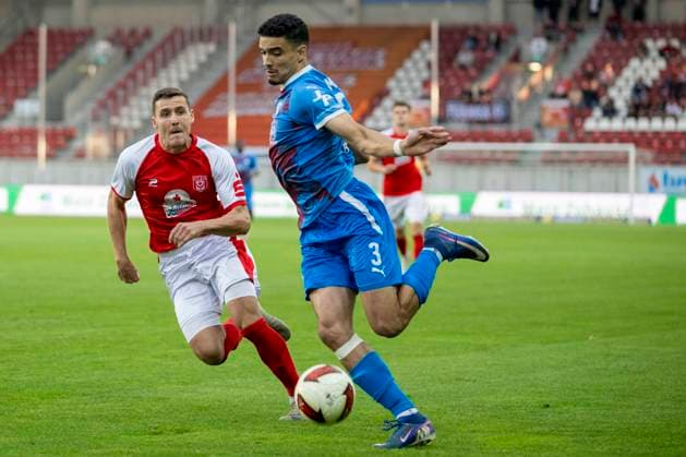 Regionalliga Northeast, Season 26–27: Hallescher FC vs. SV Tasmania Berlin, Halle, Germany, September 2, 2026. Pictured, from left: Marius Hauptmann (Halle) and Youssef Labbouz (Tasm Berlin), Halle Saale Leuna Chemie Stadium, Saxony-Anhalt, Germany
