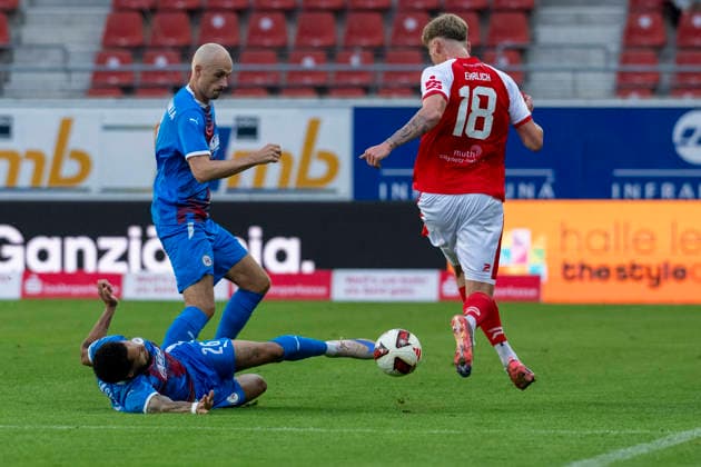 Regionalliga Northeast, Season 26–27: Hallescher FC vs. SV Tasmania Berlin, Halle, Germany, September 2, 2026. Pictured from left to right in a tackle: Deji Beyreuther (Tasm Berlin), Steffen Eder (Tasm Berlin), and Lucas Ehrlich (Halle). Halle-Saale-Leuna Chemie Stadium, Saxony-Anhalt, Germany