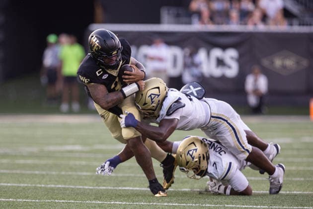 September 3, 2026: Wake Forest Demon Deacons quarterback Gio Lopez (3) is tackled by Akron Zips linebacker Eddie Smith III (19) and linebacker Jeremiah Jones (7) during the first half of the NCAA, College League, USA football match up at Allegacy Stadium in Winston-Salem, NC. Mandatory Credit: -Cal Media NCAA Football 2026: Akron At Wake Forest Sep 03  - ZUMAc04_ 20260903_zma_c04_067 Copyright: xScottxKinserx