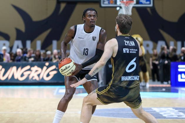 September 4, 2026, xgox, Basketball Exhibition Game: Basketball, Löwen Braunschweig vs. Bamberg Baskets, emspor, from left: Trevon Scott (Bamberg), No. 13 with the ball, playing the ball (Braunschweig)