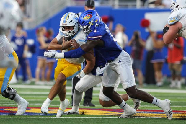LAWRENCE, KS - SEPTEMBER 04: Trey Lathan 4 of the Kansas Jayhawks tackles Luca Stanzani 11 of the Long Island University Sharks in the first quarter of a college football game between the Long Island Sharks and Kansas Jayhawks on Sep 4, 2026 at David Booth Memorial Stadium in Lawrence, KS. (Photo by Scott Winters Icon Sportswire) COLLEGE FOOTBALL: SEP 04 LIU at Kansas EDITORIAL USE ONLY Icon2609040331