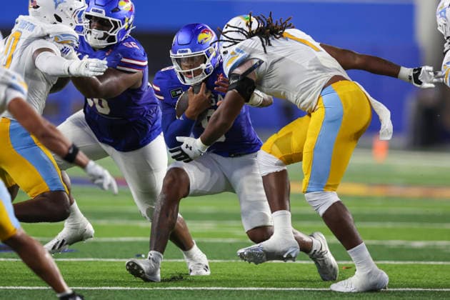 LAWRENCE, KS - SEPTEMBER 04: Jeremie McGurn 1 of the Long Island University Sharks goes in for a tackle on Isaiah Marshall 8 of the Kansas Jayhawks of the Kansas Jayhawks in the second quarter of a college football game between the Long Island Sharks and Kansas Jayhawks on Sep 4, 2026 at David Booth Memorial Stadium in Lawrence, KS. (Photo by Scott Winters Icon Sportswire) COLLEGE FOOTBALL: SEP 04 LIU at Kansas EDITORIAL USE ONLY Icon2609040352