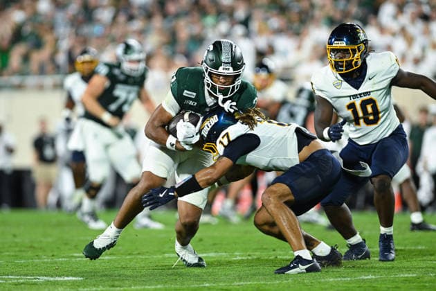 EAST LANSING, MI - SEPTEMBER 04: Michigan State Spartans tight end Jayden Savoury (31) gets wrapped up by Toledo Rockets safety Kaleb Hutchinson (17) during a college football game between the Michigan State Spartans and Toledo Rockets on September 4, 2026 at Spartan Stadium in East Lansing, MI. (Photo by Adam Ruff Icon Sportswire) COLLEGE FOOTBALL: SEP 04 Toledo at Michigan State EDITORIAL USE ONLY Icon260908014