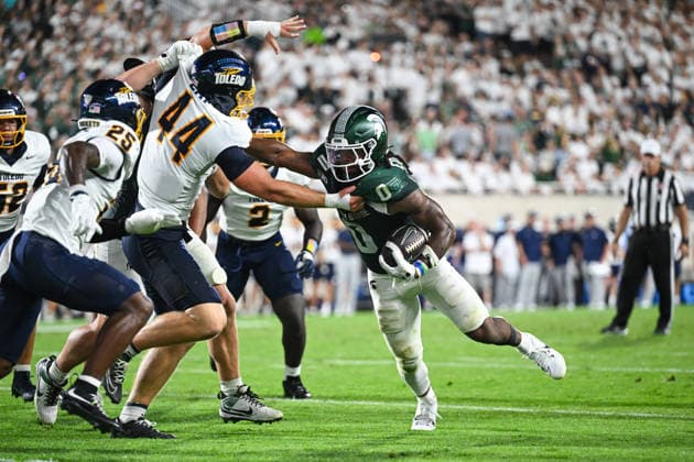 EAST LANSING, MI - SEPTEMBER 04: Michigan State Spartans running back Cam Edwards (0) delivers a stiff arm to Toledo Rockets linebacker Isaac Day (44) in the red zone during a college football game between the Michigan State Spartans and Toledo Rockets on September 4, 2026 at Spartan Stadium in East Lansing, MI. (Photo by Adam Ruff Icon Sportswire) COLLEGE FOOTBALL: SEP 04 Toledo at Michigan State EDITORIAL USE ONLY Icon260908018