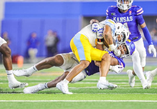 Sep 4, 2026: Kansas Jayhawks linebacker Trey Lathan (4) tackles Long Island Sharks wide receiver Josiah Brown (7) in Lawrence, KS, USA; at Memorial Stadium. Mandatory Credit: -Cal Media Lawrence USA - ZUMAc04_ 20260904_zma_c04_036 Copyright: xRomanxPunox