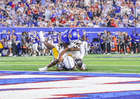 Sep 4, 2026: Kansas Jayhawks wide receiver Nahzae Cox (0) fights off a Long Island Sharks defender in Lawrence, KS, USA; at Memorial Stadium. Mandatory Credit: -Cal Media Lawrence USA - ZUMAc04_ 20260904_zma_c04_045 Copyright: xRomanxPunox