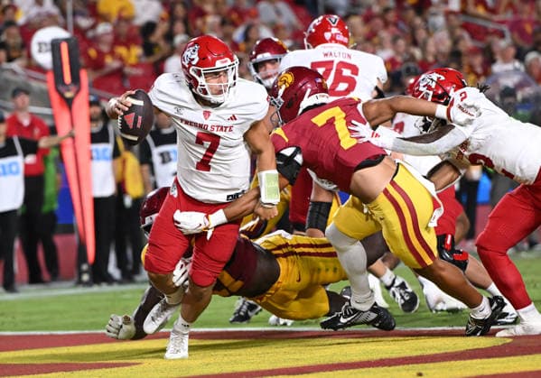 LOS ANGELES, CA - SEPTEMBER 04: Fresno State Bulldogs quarterback Jayden Mandal (7) scrambles as Southern California Trojans safety Alex Graham (7) reaches for the tackle during the game between the USC Trojans and the Fresno State Bulldogs on September 04, 2026 at Los Angeles Memorial Coliseum in Los Angeles. (Photo by David Dennis Icon Sportswire) COLLEGE FOOTBALL: SEP 04 Fresno State at USC EDITORIAL USE ONLY Icon26090432