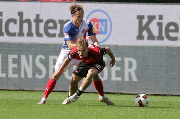 Duell zwischen Jonas Therkelsen (Holstein Kiel) und Tim Janisch (1.FC Nuernberg) Fussball, Herren, Saison 2026 2027, 2.BL, Holstein Stadion, Holstein Kiel gegen 1.FC Nuernberg DFL REGULATIONS PROHIBIT ANY USE OF PHOTOGRAPHS AS IMAGE SEQUENCES AND OR QUASI-VIDEO. *** Head-to-head between Jonas Therkelsen (Holstein Kiel) and Tim Janisch (1. FC Nuremberg) — Men s Soccer, 2026–2027 Season, 2. Bundesliga, Holstein Stadium, Holstein Kiel vs. 1. FC Nuremberg DFL regulations prohibit any use of photographs as image sequences and or quasi-video
