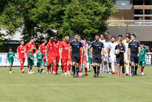 Andreas Dinger (referee), Yunis Widholz (assistant referee), and Sascha Thiemann (assistant referee) lead the teams onto the field for the match between TSV Landsberg and TSV Buchbach, soccer, men’s, Bavarian Regional League, 2026–2027, Matchday 7 on September 5, 2026, in Landsberg am Lech, Sportpark, Bavaria, Germany