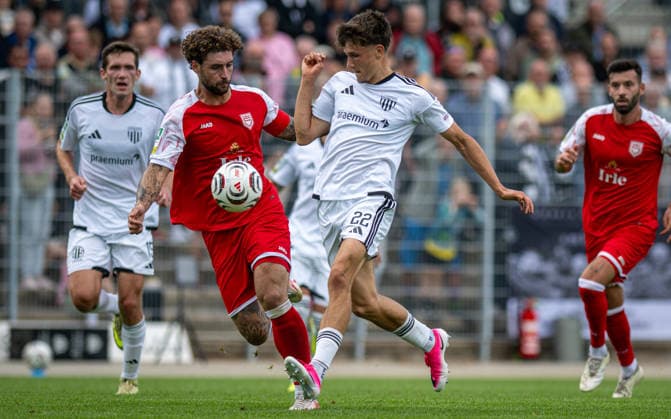 Soccer, 2026–2027 Season, Regionalliga West, September 5, 2026, Matchday 7, Men’s, 1 FC Bocholt (white) vs. Sportfreunde Siegen (red); from left: Jan Luca Rumpf (SF Siegen), Benjamin Friesen (1 FC Bocholt), Bocholt Stadion am Huenting, Germany 260905_fb_1fc-bocholt_sf-siegen_58438