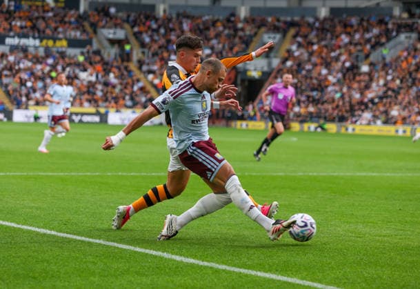 Kingston upon Hull, England, 5th September 2026. Ryan Giles (L) of Hull City in action with Matty Cash of Aston Villa during the Hull City vs Aston Villa Premier League match at the MKM Stadium, Kingston upon Hull. Picture credit should read: Nigel Roddis Sportimage EDITORIAL USE ONLY. No use with unauthorised audio, video, data, fixture lists, club league logos or live services. Online in-match use limited to 120 images, no video emulation. No use in betting, games or single club league player publications. SPI_010_NR_HULL_ASTO SPI-4974-0010