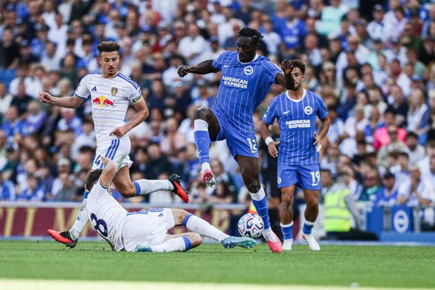 5th September 2026; American Express Stadium, Brighton, England; Premier League Football, Brighton and Hove Albion versus Leeds United; Promise David of Brighton skips over Sean Longstaff of Leeds United AndrewxSkinner