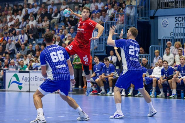 September 5, 2026, xsefx, Handball, 1st Bundesliga, VfL Gummersbach vs. MT Melsungen, 2026–2027 Men’s Season, Schwalbe Arena: Aaron Mensing (MT Melsungen, No. 33) shoots against Kristjan Horzen (VfL Gummersbach, No. 27) and Stepan Zeman (VfL Gummersbach, No. 66), North Rhine-Westphalia, Germany