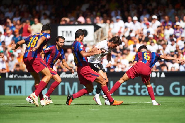 Rodrigo Hernandez of FC Barcelona and Jesus Vazquez of Valencia CF during the LaLiga EA Sports match between Valencia CF and FC Barcelona at Mestalla on September 6, 2026, in Valencia, Spain