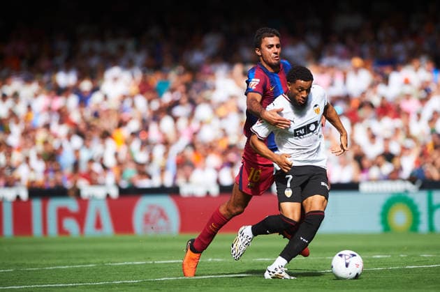 Rodrigo Hernandez of FC Barcelona and Arnaut Danjuma of Valencia CF during the LaLiga EA Sports match between Valencia CF and FC Barcelona at Mestalla on September 6, 2026, in Valencia, Spain