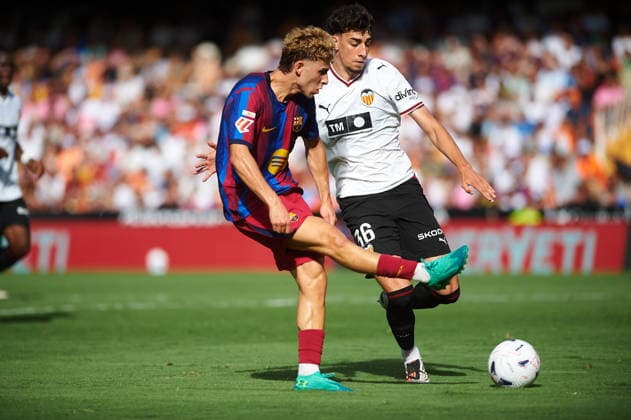 Fermin Lopez of FC Barcelona and Iker Cordoba of Valencia CF during the LaLiga EA Sports match between Valencia CF and FC Barcelona at Mestalla on September 6, 2026, in Valencia, Spain