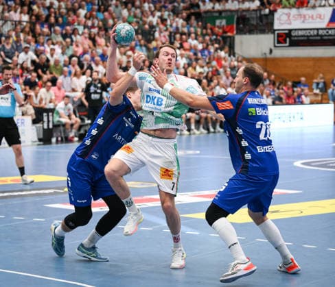 Handball 1 Bundesliga 2025–2026, June 9, 2026: HBW Balingen Weilstetten vs. SC Magdeburg; Magnus Saugstrup (center), SC Magdeburg, against Mex Raguse (left), HBW Balingen Weilstetten, and Tobias Heinzelmann (right), HBW Balingen Weilstetten