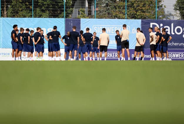 Soccer, Men s, Bavarian Regional League, 2026–2027 Season, TSV 1860 Munich, Training at Grünwalder Strasse 114, Training Facility The TSV 1860 Munich team standing together in a circle on the training field