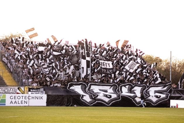 VfR Aalen vs. SSV Ulm 1846 Soccer, Regionalliga Südwest, Matchday 6, Bediani Arena, Aalen, September 8, 2026. SSV Ulm 1846 soccer fans performing a choreographed display in the visitors section. Fan section for VfR Aalen vs. SSV Ulm 1846 soccer, Regionalliga Southwest, Matchday 6, Bediani Arena, Aalen, September 8, 2026. Photo by Lucca Fundel, Aalen, Bediani Arena, Baden-Württemberg, Germany
