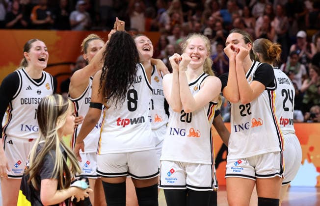 Nyara Sabally, Frieda Bühner, Emily Bessoir; German fans cheer and celebrate reaching the quarterfinals; Sport: Basketball; FIBA World Cup; Women s World Championship; 2026–2027 season; August 9, 2026; DBB Germany (GER) vs. South Korea (KOR)