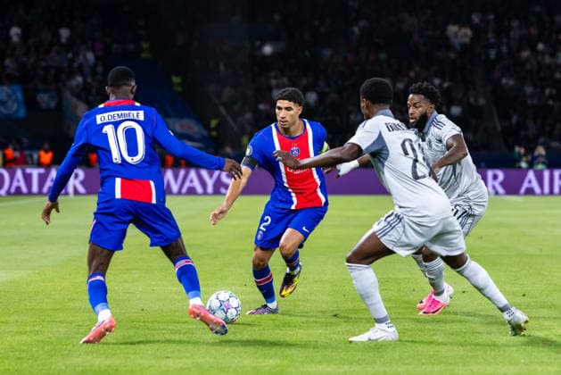 Ousmane Dembele of PSG, Achraf Hakimi of PSG, Suleiman Camara of SK Slovan Bratislava and Sandro Cruz of SK Slovan Bratislava during UEFA Champions league League phase game between teams PSG and SK Slovan Bratislava (Dominika Kortvelyesiova Ball Raw Images) Paris Parc des Princes France Copyright: xDominikaxKortvelyesiovax DKR_8922