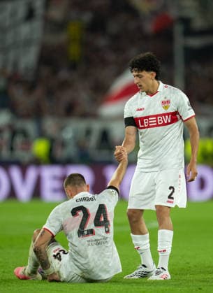 Ameen Al Dakhil of VfB Stuttgart helps Jeff Chabot of VfB Stuttgart to get up during UEFA Champions League - Matchday 1 season 26 27 game between Stuttgart and Viking (Ruslan Taran Ball Raw Images) Stuttgart MHP Arena Germany Copyright: xRuslanxTaranx RUS_STUTT-VIKING-0489
