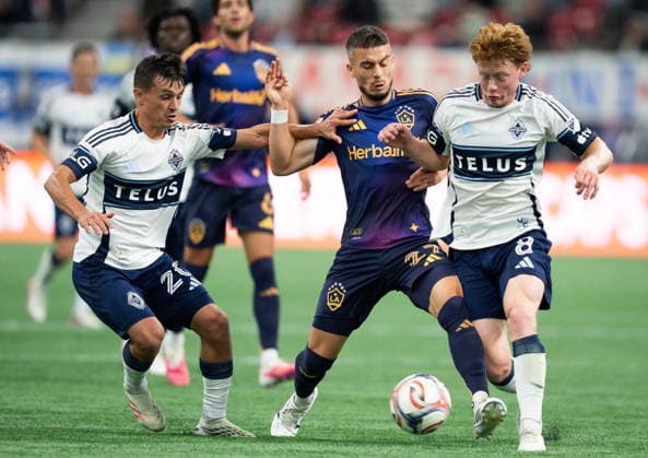 September 9, 2026, Vancouver, Bc, CANADA: Vancouver Whitecaps Andres Cubas (20) and Oliver Larraz (8) stop Los Angeles Galaxy s Erik Thommy (27) during the second half of an MLS, Fussball Herren, USA soccer match in Vancouver on Wednesday, Sept. 9, 2026. Canada News - September 9, 2026  - ZUMAc35_ 20260909_zaf_c35_163 Copyright: xEthanxCairnsx