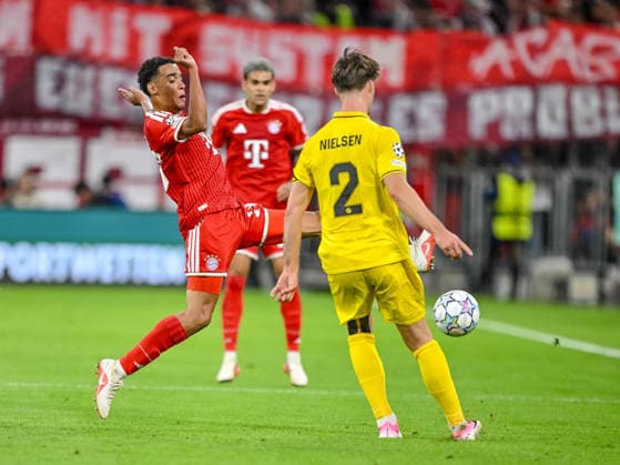 Jamal Musiala of FC Bayern Munich and Villads Nielsen of FK Bodo Glimt battle for the ball during the 2026–2027 UEFA Champions League match between Bayern Munich and Bodo Glimt at Fussball Arena Munich on September 10, 2026 in Munich, Germany. Photo by Harry Langer, DeFodi Images