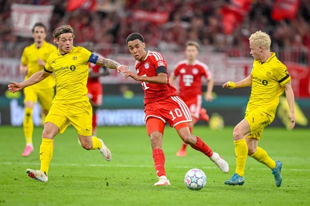 Patrick Berg (FK Bodo Glimt), Jamal Musiala (FC Bayern Munich), and Sondre Auklend (FK Bodo Glimt) battle for the ball during the 2026–2027 UEFA Champions League match between Bayern Munich and Bodo Glimt at Fussball Arena Munich on September 10, 2026 in Munich, Germany. Photo by Harry Langer, DeFodi Images