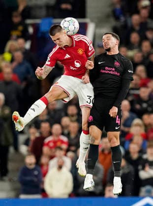Manchester, England, 10th September 2026. Benjamin Sesko of Manchester United, ManU challenges Aden McCarthy of Sabah FC during the Manchester United vs Sabah UEFA Champions League match at Old Trafford, Manchester. Picture credit should read: Andrew Yates Sportimage EDITORIAL USE ONLY. No use with unauthorised audio, video, data, fixture lists, club league logos or live services. Online in-match use limited to 120 images, no video emulation. No use in betting, games or single club league player publications. SPI_049_AY_Man_Utd_Sabah SPI-4989-0049