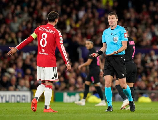 Manchester, England, 10th September 2026. Referee Willy Delajod talks to Bruno Fernandes of Manchester United, ManU during the Manchester United vs Sabah UEFA Champions League match at Old Trafford, Manchester. Picture credit should read: Andrew Yates Sportimage EDITORIAL USE ONLY. No use with unauthorised audio, video, data, fixture lists, club league logos or live services. Online in-match use limited to 120 images, no video emulation. No use in betting, games or single club league player publications. SPI_050_AY_Man_Utd_Sabah SPI-4989-0050