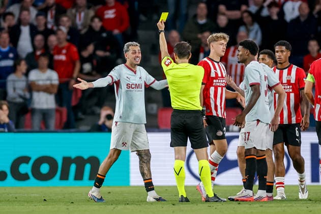 EINDHOVEN, NETHERLANDS - SEPTEMBER 10: Isaque of Shakhtar receives a yellow card from referee Umut Meler during the UEFA Champions League match between PSV Eindhoven and FC Shakhtar Donetsk at PSV Stadion on September 10, 2026 in Eindhoven, Netherlands.  Copyright: xMTB MBxMediax