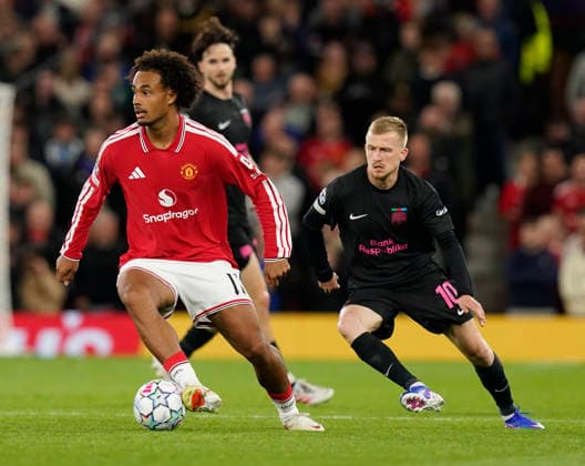 Manchester, England, 10th September 2026. Joshua Zirkzee of Manchester United, ManU tracked by Aleksey Isaev of Sabah FC during the Manchester United vs Sabah UEFA Champions League match at Old Trafford, Manchester. Picture credit should read: Andrew Yates Sportimage EDITORIAL USE ONLY. No use with unauthorised audio, video, data, fixture lists, club league logos or live services. Online in-match use limited to 120 images, no video emulation. No use in betting, games or single club league player publications. SPI_054_AY_Man_Utd_Sabah SPI-4989-0053