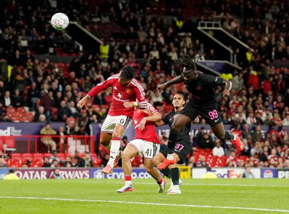 Manchester, England, 10th September 2026. Orphe Mbina of Sabah FC heads over during the Manchester United, ManU vs Sabah UEFA Champions League match at Old Trafford, Manchester. Picture credit should read: Andrew Yates Sportimage EDITORIAL USE ONLY. No use with unauthorised audio, video, data, fixture lists, club league logos or live services. Online in-match use limited to 120 images, no video emulation. No use in betting, games or single club league player publications. SPI_063_AY_Man_Utd_Sabah SPI-4989-0063