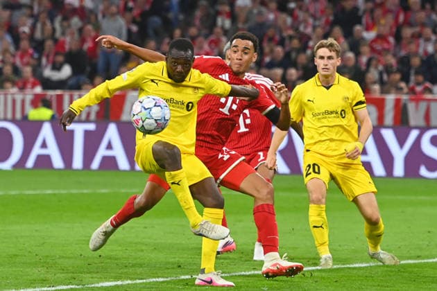 Jamal MUSIALA Bayern Munich, Action, Tackle against Assan Sanyang (Glimt) vs. Fredrik Sjoevold (Glimt), Soccer, Champions League, 2026–27 Season, Group stage: FC Bayern Munich vs. Bodo Glimt, 5–0 on September 10, 2026