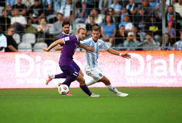 Soccer, Men s, Bavarian Regional League, 2026–2027 Season, TSV 1860 Munich vs. Schwaben Augsburg; at Grünwalder Stadium, Rasmus Fackler (Schwaben Augsburg, left) and Florian Niederlechner (TSV 1860 Munich, right) battle for the ball