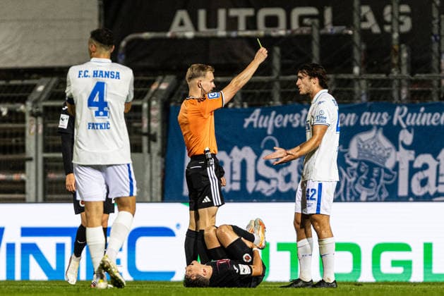 3rd Division: FC Viktoria Köln vs. Hansa Rostock, September 11, 2026. Sebastian Hilsberg, referee from Mainz, shows a yellow card to Benno Dietze of Hansa Rostock, 42. 3rd Division: FC Viktoria Köln vs. Hansa Rostock at Sportpark Höhenberg, Cologne, September 11, 2026. DFB regulations prohibit any use of photographs as image sequences and or quasi-video. Copyright: xBEAUTIFULxSPORTS Buriakovx
