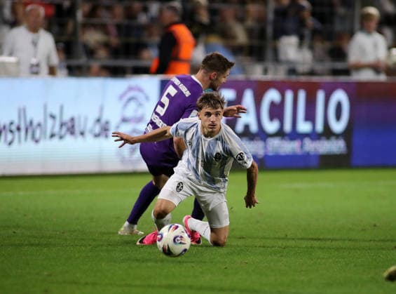Soccer, Men s, Bavarian Regional League, 2026–2027 Season, TSV 1860 Munich vs. Schwaben Augsburg; at Grünwalder Stadium, Dennis Ruisinger of Schwaben Augsburg fouls Mark Gevorgyan of TSV 1860 Munich from behind during a tackle for the ball