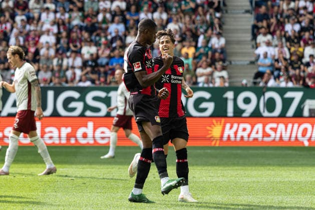 Deutschland: FC Augsburg vs Bayer 04 Leverkusen, 1. Bundesliga, Saison 2026 27, WWK Arena (Augsburg): Christian Kofane, (Bayer Leverkusen, 35) jubelt nach seinem Tor mit Afonso Moreira, (Bayer Leverkusen, 9) Augsburg WWK Arena Bayern Deutschland *** Germany: FC Augsburg vs. Bayer 04 Leverkusen, Bundesliga 1, 2026–27 Season, WWK Arena, Augsburg. Christian Kofane (Bayer Leverkusen, 35) celebrates his goal with Afonso Moreira (Bayer Leverkusen, 9). Augsburg, WWK Arena, Bavaria, Germany Copyright: xBenedictxChristx