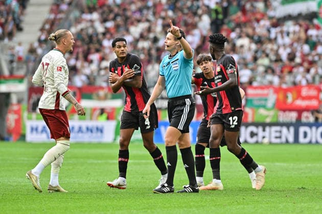 1. Fussball Bundesliga: FC Augsburg - Bayer 04 Leverkusen, 12.09.2026 AUGSBURG, GERMANY; 12. SEPTEMBER: Referee Daniel SIEBERT nimmt den Ausgleich der Leverkusener nach Videobeweis zurück Edmond TAPSOBA (Bayer Leverkusen 12) kann es nicht versehen während dem Match der Bundesliga zwischen dem FC Augsburg und Bayer 04 Leverkusen am 3. Spieltag in der WWK-Arena DFL REGULATIONS PROHIBIT ANY USE OF PHOTOGRAPHS AS IMAGE SEQUENCES AND OR QUASI-VIDEO Marius WOLF (FC Augsburg 27), Jarell QUANSAH (Bayer Leverkusen 4), Afonso MOREIRA (Bayer Leverkusen 9) *** 1 Bundesliga Soccer: FC Augsburg vs. Bayer 04 Leverkusen, September 12, 2026, AUGSBURG, GERMANY SEPTEMBER 12 Referee Daniel SIEBERT overturns Leverkusen’s equalizer following a video review Edmond TAPSOBA of Bayer Leverkusen 12 is unable to react during the Bundesliga match between FC Augsburg and Bayer 04 Leverkusen on Matchday 3 at the WWK Arena. DFL regulations prohibit any use of photographs as image sequences and or quasi-video. Marius WOLF (FC Augsburg, 27), Jarell QUANSAH (Bayer Leverkusen, 4), Afonso MOREIRA (Bayer Leverkusen, 9) Copyright: xBEAUTIFULxSPORTS Goldbergx