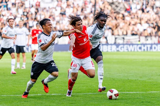 MAINZ, GERMANY - SEPTEMBER 12: Kaishu Sano (1. FSV Mainz 05, 6) is challenged by Keita Kosugi (Eintracht Frankfurt, 26) during the Bundesliga match between 1. FSV Mainz 05 vs. Eintracht Frankfurt at MEWA Arena on matchday 3 of the 1. Bundesliga on September 12, 2026 in Mainz, Germany. DFL REGULATIONS PROHIBIT ANY USE OF PHOTOGRAPHS AS IMAGE SEQUENCES AND OR QUASI-VIDEO. Rhineland-Palatinate Germany Copyright: xStephanxHahnex