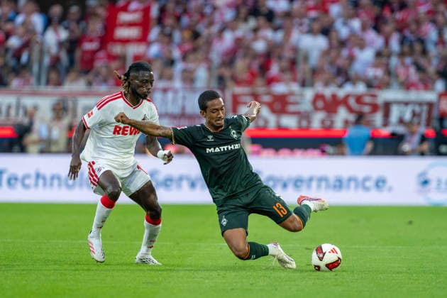 Gideon Mensah (1.FC Koeln, 14) im Zweikampf mit Arthur (SV Werder Bremen, 13) der den Ball beim graetschen passt 1.FC Köln vs. SV Werder Bremen, Fussball, Bundesliga, 3.Spieltag, Saison 2026 27, 12.09.2026, DFL REGULATIONS PROHIBIT ANY USE OF PHOTOGRAPHS AS IMAGE SEQUENCES AND OR QUASI-VIDEO, 1.FC Köln vs. SV Werder Bremen, Fussball, Bundesliga, 3.Spieltag, Saison 2026 27, 12.09.2026 Köln *** Gideon Mensah of 1. FC Köln, No. 14, in a tackle with Arthur of SV Werder Bremen, No. 13, who passes the ball while sliding, 1. FC Köln vs. SV Werder Bremen, Soccer, Bundesliga, Matchday 3, 2026–27 season, September 12, 2026, DFL regulations prohibit any use of photographs as image sequences and or quasi-video, 1. FC Köln vs. SV Werder Bremen, soccer, Bundesliga, Matchday 3, 2026–27 season, September 12, 2026, Cologne Copyright: xEibner-Pressefoto LukasxBaldygax EP_LBA
