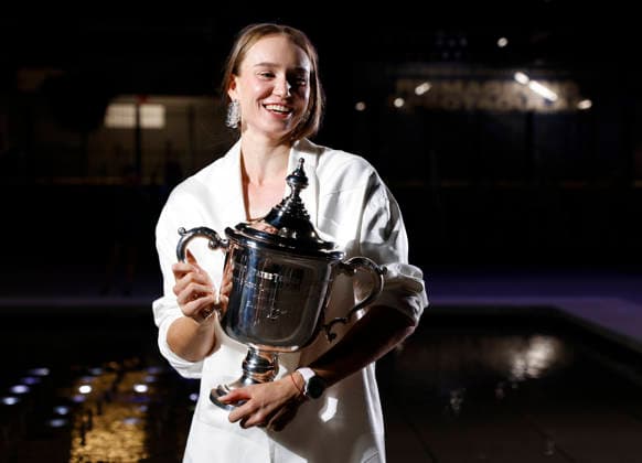 Elena Rybakina of Kazakhstan holds the championship trophy at the fountains in front of Arthur Ashe Stadium after defeating Aryna Sabalenka of Belarus in the Women s Finals match at the 2026 US Open Tennis Championship at the USTA Billie Jean King National Tennis Center in New York City on Saturday, September 12, 2026. Rybakina won with a score of 6-4, 5-7, 6-2.  NYP20260913204 JOHNxANGELILLO