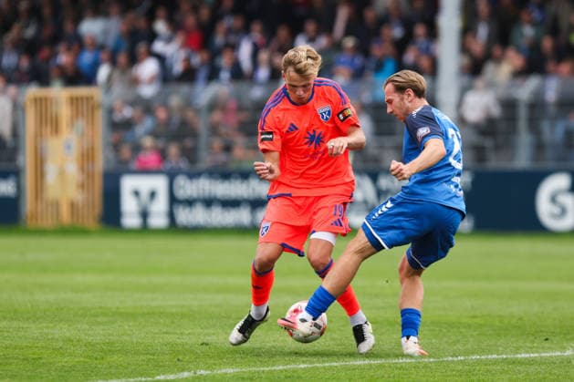 September 12, 2026, Soccer, Men s, Regionalliga Nord, Matchday 8, BSV Kickers Emden vs. SSV Jeddeloh II Marvin Benjamin in his orange jersey, No. 19, of BSV Kickers Emden in a tackle with Tim Janßen, No. 20, of SSV Jeddeloh II