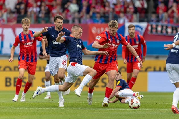 Fierce tackle: Ivan Nekic (Holstein Kiel, 13) challenges Alessandro Vogt (1 FC Heidenheim, 18), misses, and Jonas Meffert (Holstein Kiel, 28), GER, 1 FC Heidenheim vs. Holstein Kiel, soccer, 2. Bundesliga, Matchday 5, 2026–2027 season, September 13, 2026, DFL and DFB regulations prohibit any use of photographs as image sequences and or quasi-video, GER, 1 FC Heidenheim vs. Holstein Kiel, Soccer, 2. Bundesliga, Matchday 5, 2026–2027 Season, September 13, 2026, Heidenheim Copyright: xEibner-Pressefoto JanixPlessx EP_JPL