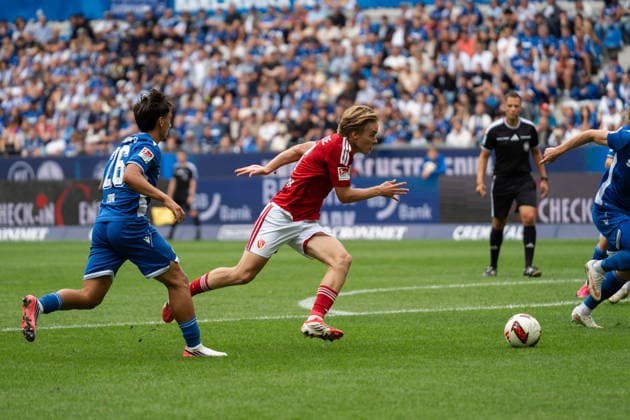 September 13, 2026, xjyhynx, Soccer 2. Bundesliga, Karlsruher SC vs. Energie Cottbus, Danyal Zor 26, Karlsruher SC in a tackle with Lukas Michelbrink 8, Energie Cottbus. DFL and DFB regulations prohibit any use of photographs as image sequences and or quasi-video. Karlsruhe